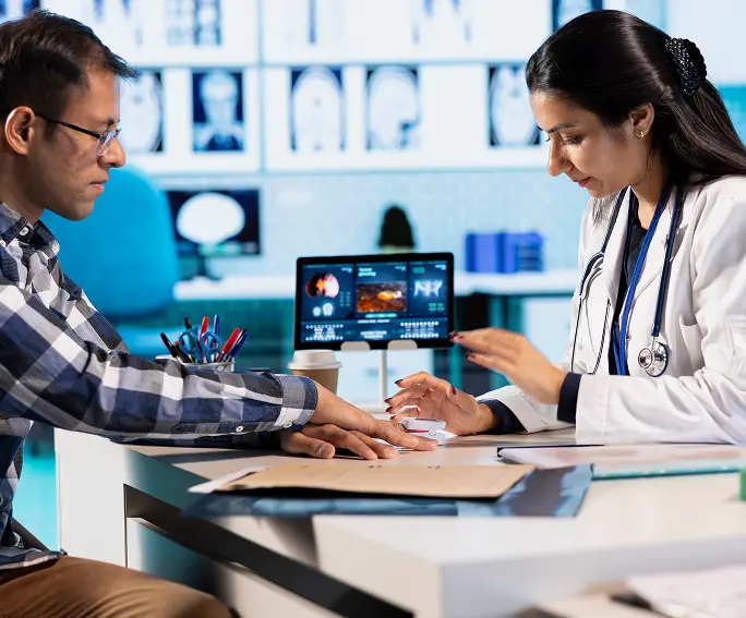 Clinician reviewing patient information across multiple screens