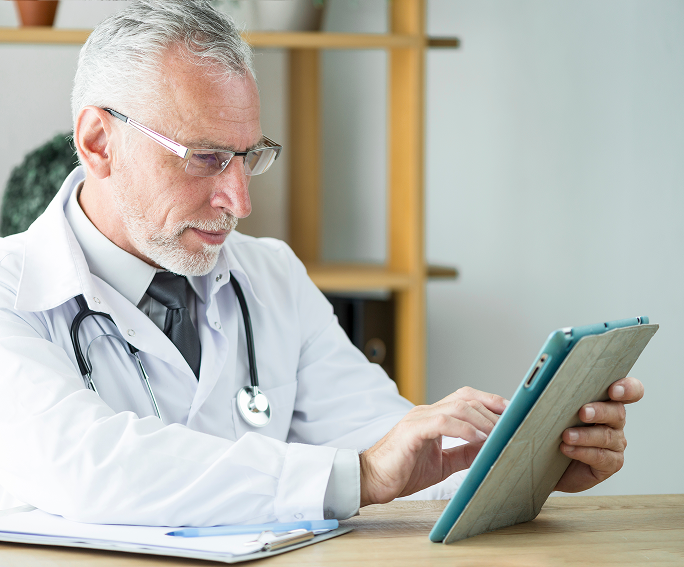 Clinician reviewing a consultation on a tablet